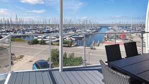 A balcony with a view of a marina filled with boats.