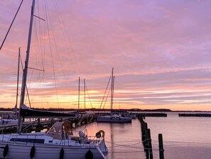 A marina with boats docked, calm water, and a sunset sky. - 4 Person Holiday Home in Farso (Farso)