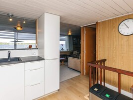 Una cocina moderna con estufa integrada, un lavamanos y ventana con vistas al agua.