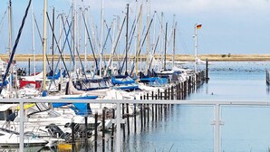 A marina with multiple boats docked at wooden piers. - 5 Star Holiday Home in Wendtorf (Wendtorf)