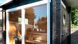 A wooden deck with a bench and a glass door leading to an interior space. - 8 Person Holiday Home in Gilleleje (Gilleleje)