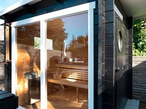 A wooden deck with a bench and a glass door leading to an interior space. - 8 Person Holiday Home in Gilleleje (Gilleleje)
