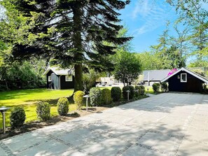 A paved driveway leading to a building with a dark roof and a small window. - 4 Star Holiday Home in Gilleleje (Gilleleje)