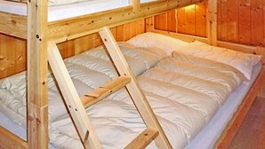 A bunk bed with a wooden frame and white bedding. - 6 Person Holiday Home in Olden (Stryn)