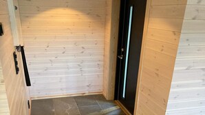 A narrow hallway with wooden walls and a black door. - 8 Person Holiday Home in Sveio-by Traum (Sveio)