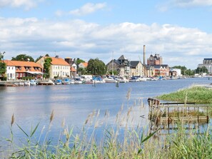 A riverside town with historic buildings, a marina with boats, and a calm water body. - 4 Star Holiday Home in Yngsjo, Sverige (Yngsjo)