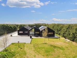 A modern two-story house with a large deck and a covered outdoor area. - 10 Person Holiday Home in Jerup (Jerup)
