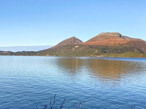 A calm lake with mountains in the background. - 6 Person Holiday Home in Halsanaustan (Heim)