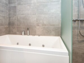 A modern bathroom with a freestanding bathtub, a showerhead, and a glass shower enclosure. - 4 Person Holiday Home in Ringkobing-by Traum (Ringkobing)