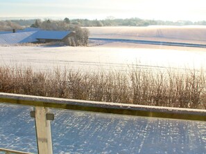 A snow-covered landscape with a barn and fields. - 14 Person Holiday Home in Havndal (Havndal)