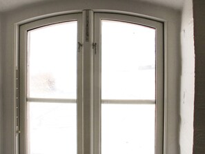 A white-framed door with a curved top and a handle on the right side. - 14 Person Holiday Home in Havndal (Havndal)