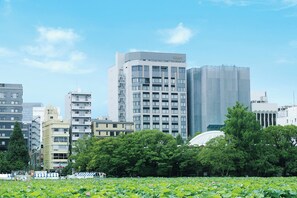 A cityscape with modern buildings, including a prominent hotel with a sign.