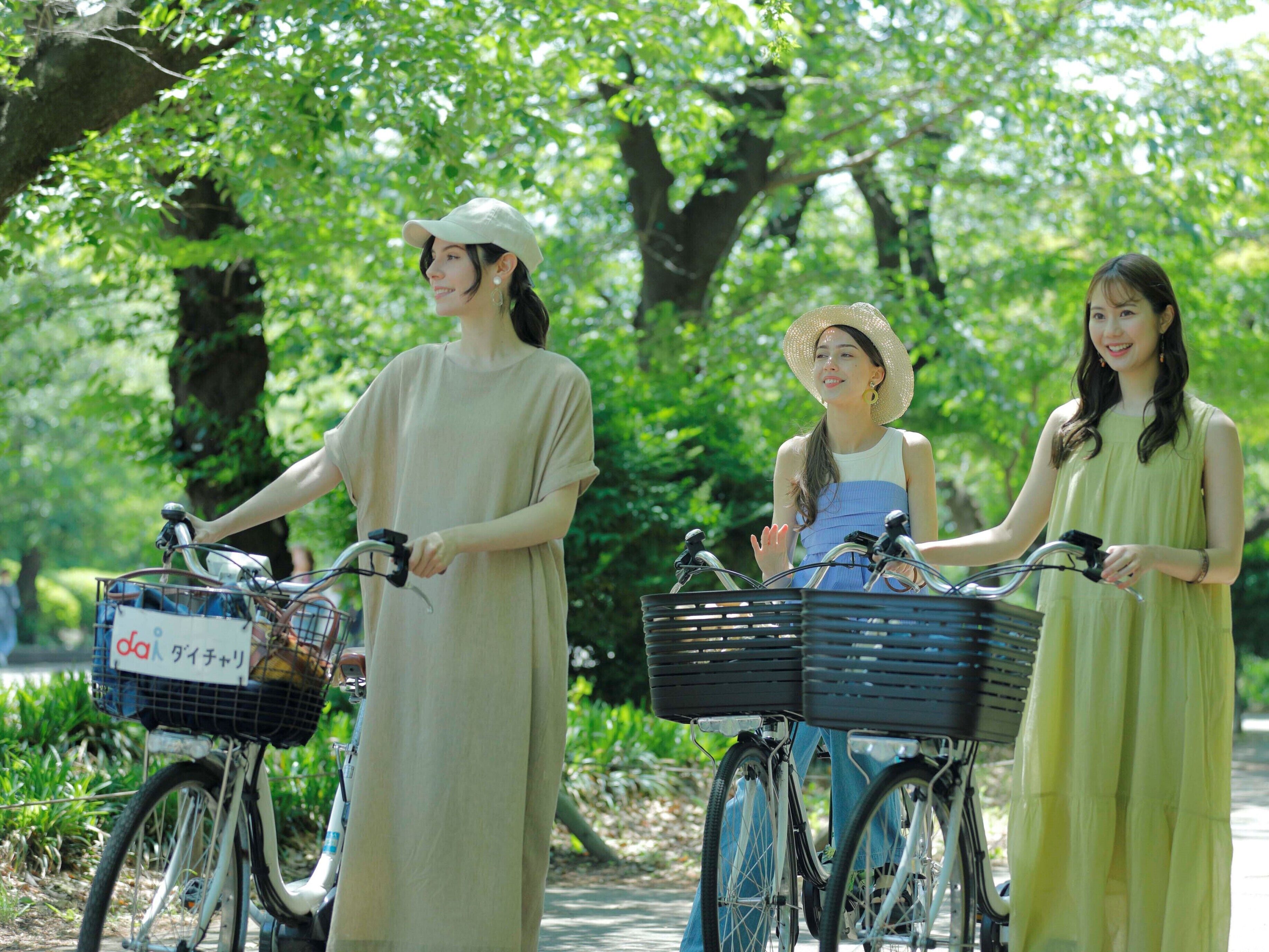 Three people on bicycles in a park with trees and greenery.