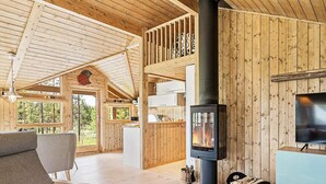 A cozy cabin interior with a fireplace, a television, and a dining area. - 6 Person Holiday Home in Tisleidalen-by Traum (Nord-Aurdal)
