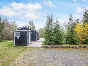 A small, single-story building with a sloped roof, a front door, and a window. - 6 Person Holiday Home in Ebeltoft (Ebeltoft)