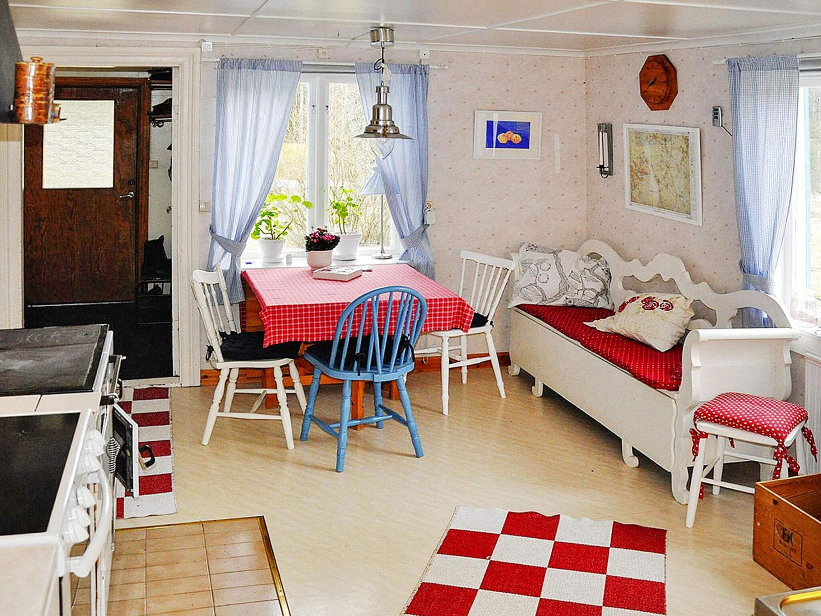 A cozy room with a dining table, chairs, a sofa, and a bed.