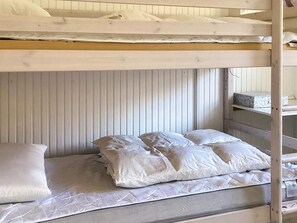A bunk bed with a mattress and pillows.