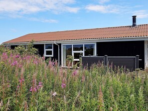 A house with a brown roof, white-framed windows, and a chimney. - 4 Star Holiday Home in Hjorring (Hjørring)