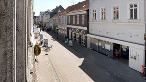 A street with buildings, a signboard, and a clear sky. - 4 Person Holiday Home in Nakskov (Nakskov)