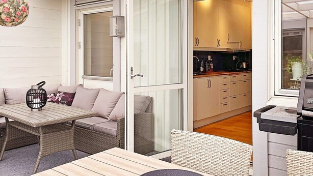 An open-plan living space with a dining area, kitchen, and a view into the kitchen. - 6 Person Holiday Home in Bjorklinge-by Traum (Björklinge)