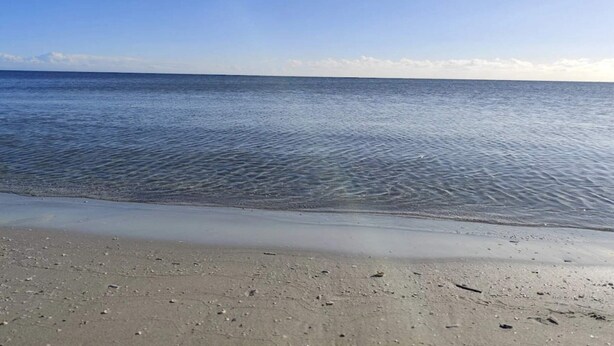 A beach with clear water and a sandy shore. - 8 Person Holiday Home in Hals (Hals)