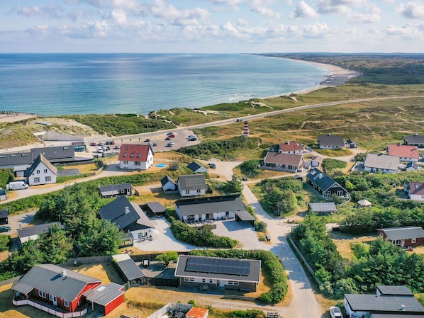 An aerial view of a coastal residential area with houses, a beach, and a road. - 5 Star Holiday Home in Thisted (Thisted)