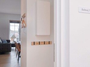 Una sala moderna con sofá, mesa de comedor y ventana.