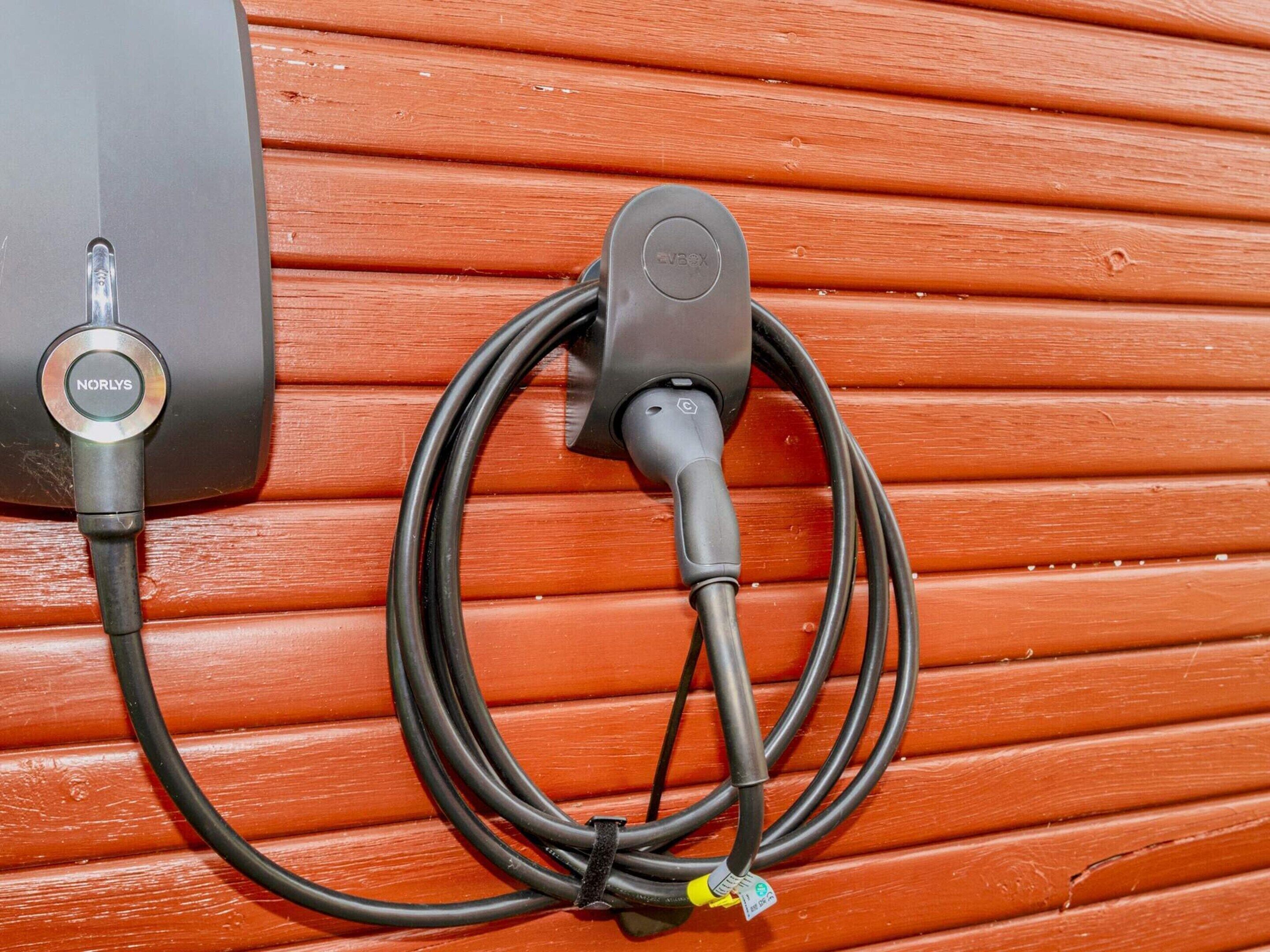 Une borne de recharge avec un câble relié à un appareil.