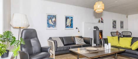 A modern living room with a sofa, armchair, and coffee table.