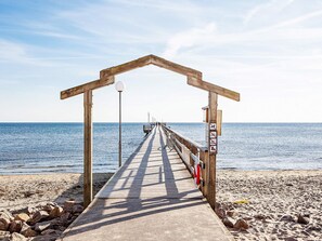 A wooden pier leading to a beach with a clear sky. - 4 Star Holiday Home in Laholm (Skummesloevsstrand)