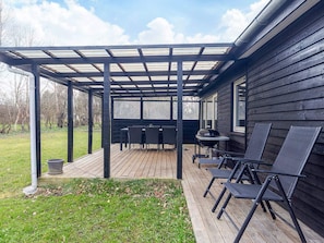 An outdoor patio with a pergola, a grill, and outdoor seating. - 6 Person Holiday Home in Hals (Hals)