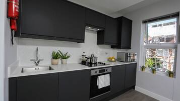 Family Apartment | Private kitchen | Full-size fridge, oven, stovetop, electric kettle