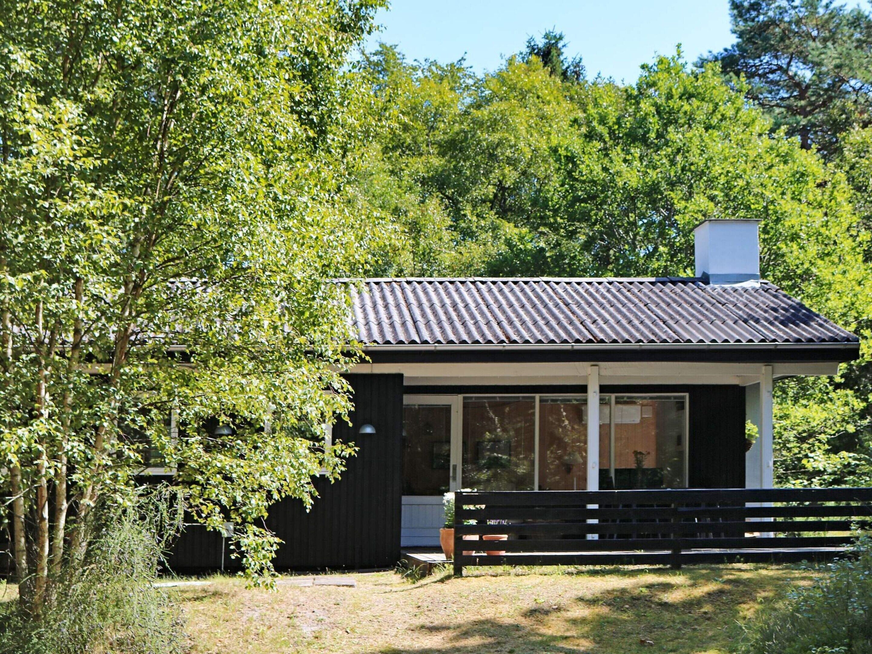 A modern, single-story building with a dark exterior and a sloped roof.