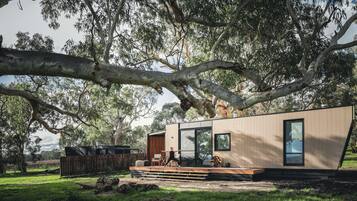 Situated in a serene natural setting, this single-story building offers expansive views of the surrounding landscape from its large windows.