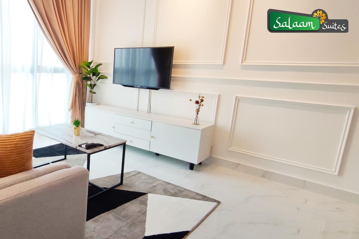 A modern living room with a sofa, coffee table, and TV.