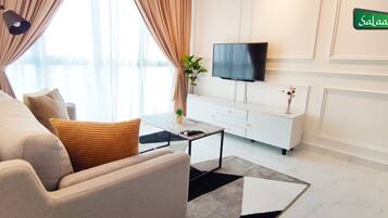 A modern living room with a sofa, coffee table, and TV.