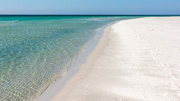 A beach with clear turquoise water and white sand. - 7 Person Holiday Home in Nexo (Nexø)