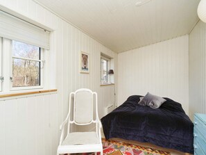 A bedroom with a bed, a chair, and a window. - 4 Star Holiday Home in Vejby (Vejby)