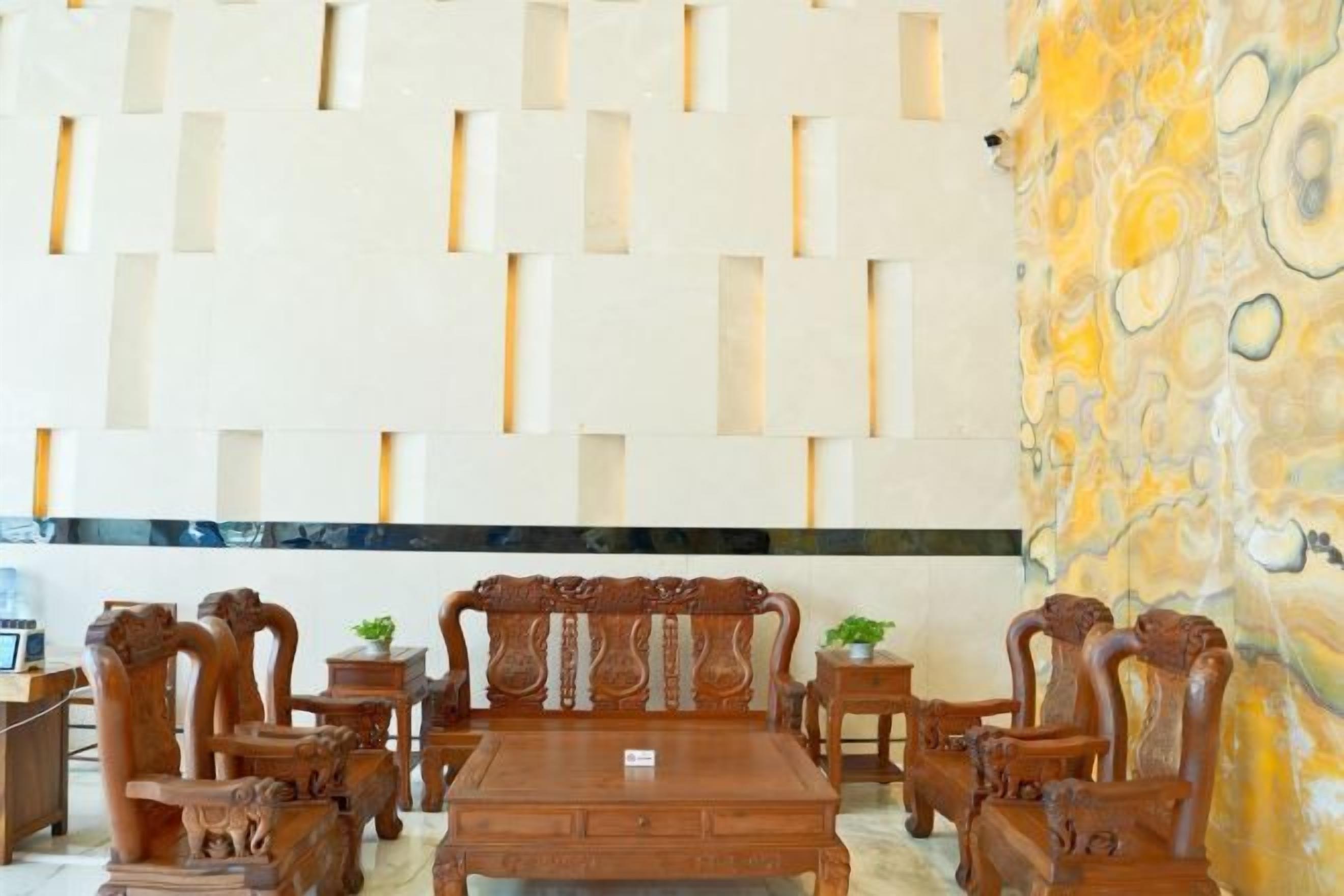 A room with a wooden dining set, a patterned wall, and a stone accent wall.