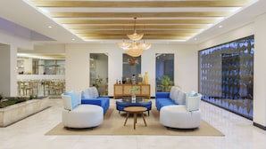 A spacious living area with two sofas, a coffee table, and a chandelier.