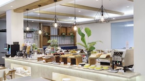 A modern breakfast bar with a variety of food items and a coffee machine.