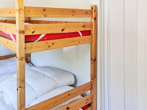 A bunk bed with white bedding and a red pillow. - 6 Person Holiday Home in Hals (Hals)