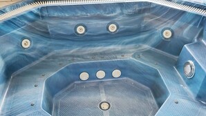 A hot tub with a hexagonal shape, multiple drain holes, and a textured floor. - 4 Star Holiday Home in Tarm (Hemmet)