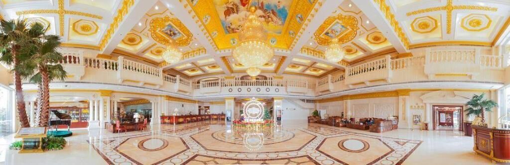 A grand lobby with a central fountain, multiple seating areas, and a high ceiling with intricate designs.