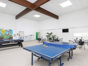 A spacious indoor area with ping pong tables, a reception desk, and potted plants. - 6 Person Holiday Home in Brovst (Brovst)