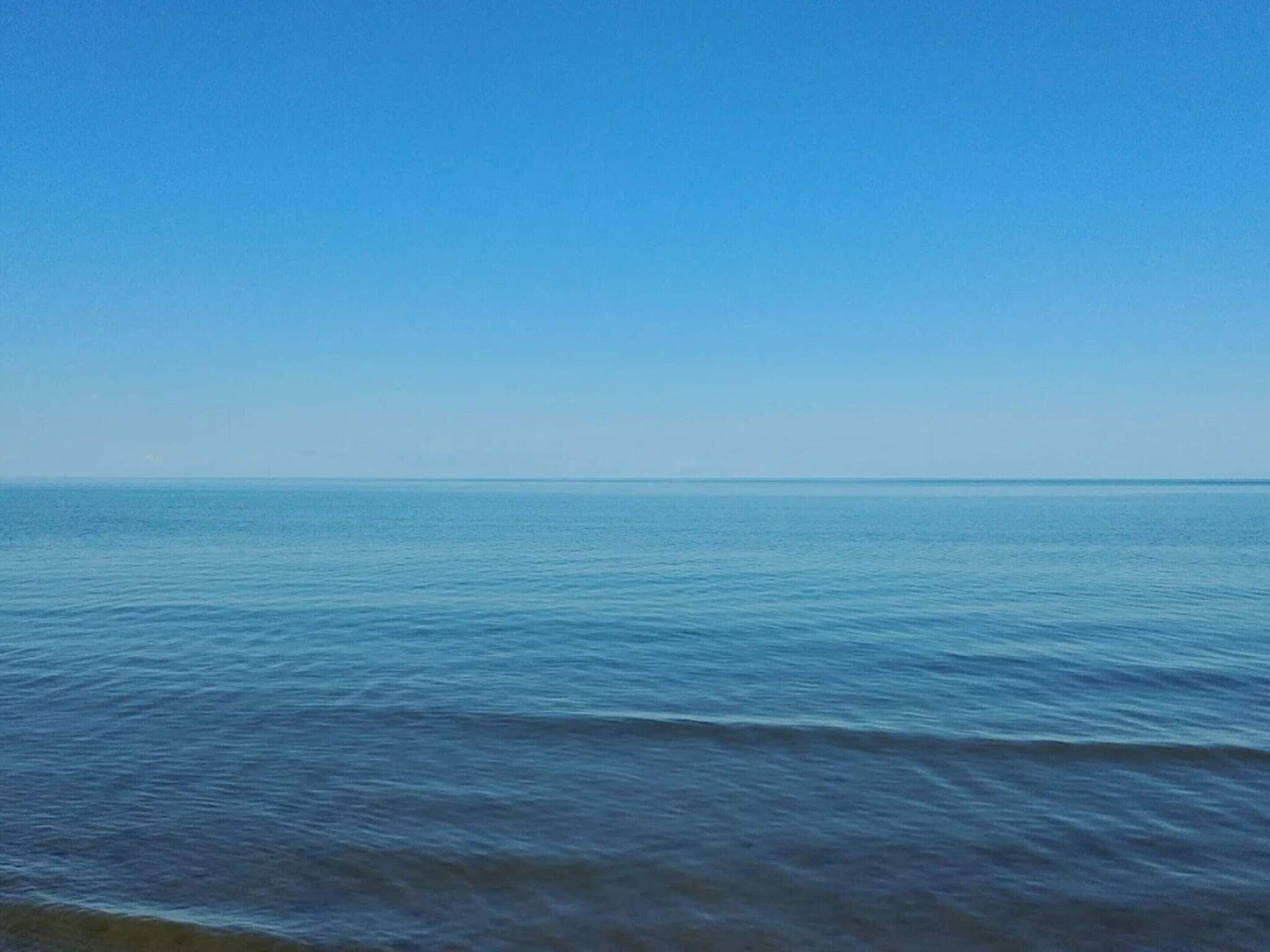 A calm sea under a clear sky.