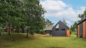 A modern house with a stone fire pit in the yard. - 6 Person Holiday Home in Hals-by Traum (Hals)
