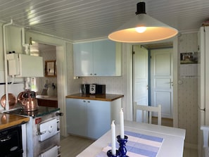 A compact kitchen with a microwave, a small refrigerator, and a wooden countertop. - 6 Person Holiday Home in Grastorp (Grastorp)