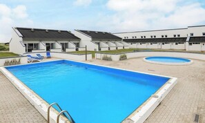 A modern hotel with a large swimming pool, guest rooms, and a covered outdoor area. - 6 Person Holiday Home in Brovst-by Traum (Brovst)