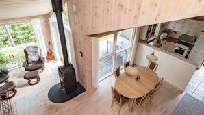 A modern interior with a fireplace, dining area, and kitchen. - 6 Person Holiday Home in Albaek (Aalbaek)